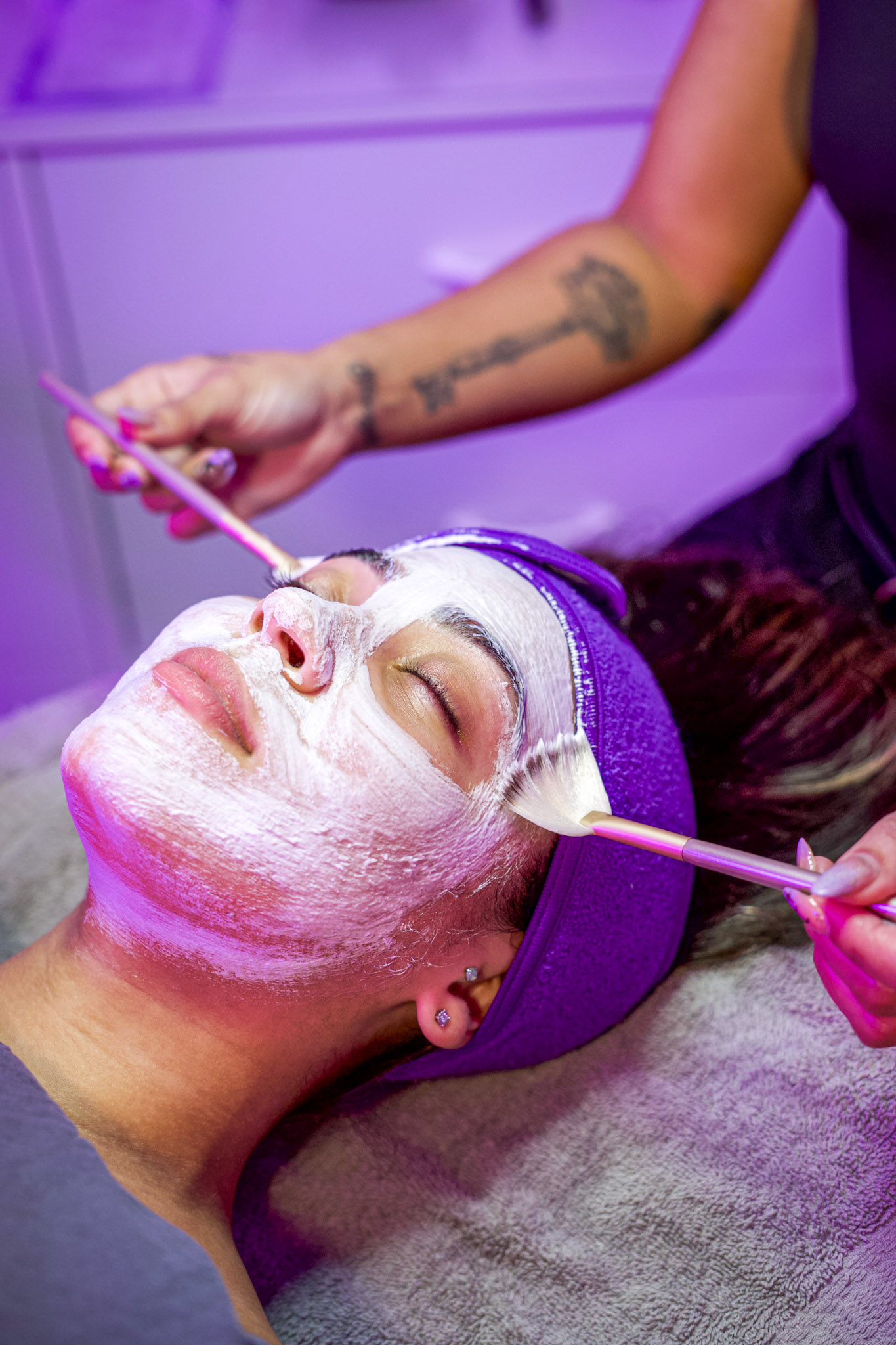 Client receiving facial mask treatment